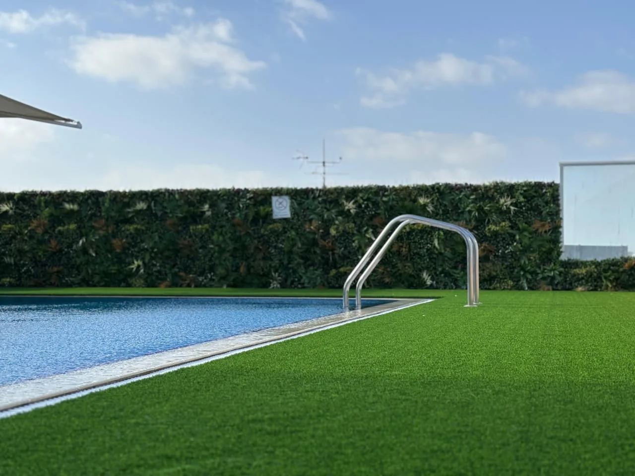 Artificial green wall panel on a balcony exterior